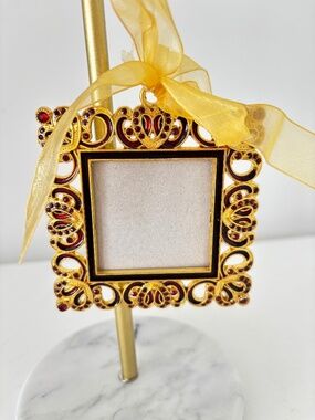 Miniature picture frame gold tone metal with red coloured stones ribbon hanger